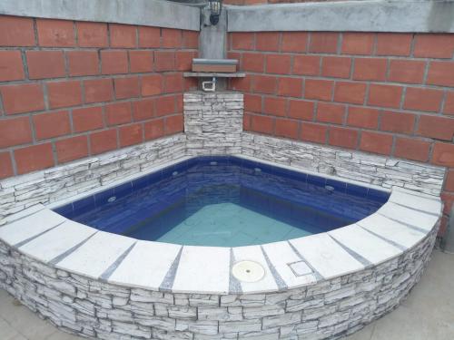 a swimming pool in a brick wall at Casa de Veraneo in Mariquita
