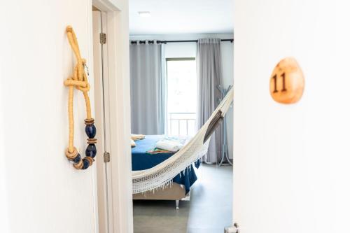 a bedroom with a hammock and a bed at Pousada do Lago in Guaramiranga