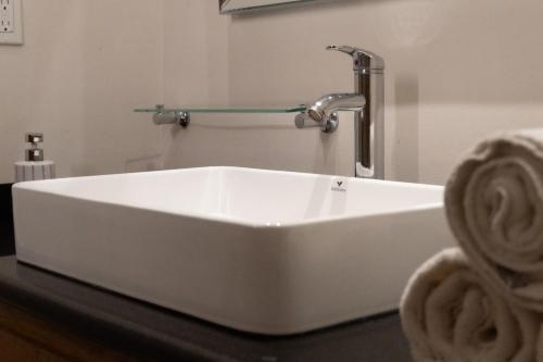 a white sink with a faucet on a table at Infinity Suites triple room 212 in Cancún