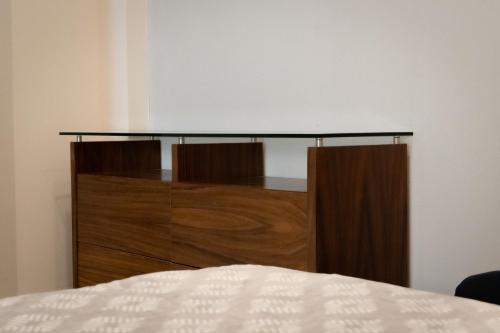 a headboard of a bed in a room at Infinity Suites triple room 212 in Cancún