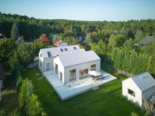 an overhead view of a white house on a lawn at Elegant holiday residence with privat sauna close to Baltic Sea on Wolin Island in Wisełka