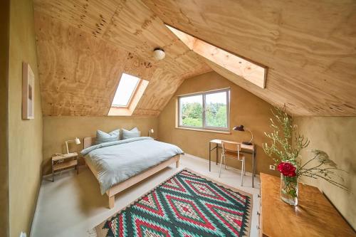 a bedroom with a bed and a window and a rug at Elegant holiday residence with privat sauna close to Baltic Sea on Wolin Island in Wisełka