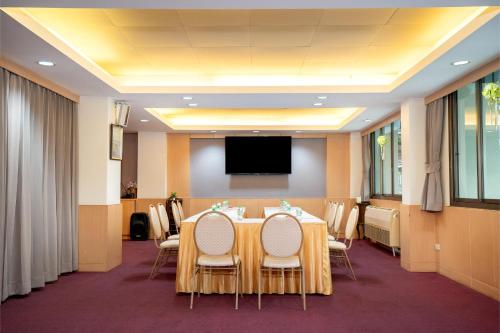 a conference room with a table and a flat screen tv at P-Park Hotel Bangkok in Bangkok