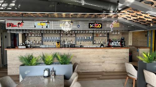 a bar in a restaurant with a table and plants at 01 Nova Otel in Didim