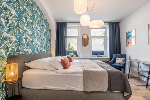 a bedroom with a large bed with a blue and green wall at 90 RELAX HOMEDESIGN Apartment in Elmshorn bei Hamburg in Elmshorn