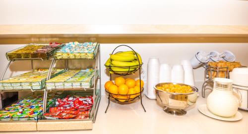 a shelf filled with lots of different types of food at Hotel Brossard in Brossard