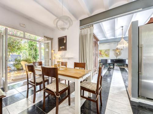 a dining room with a table and chairs and a piano at Holiday Home Ave de Paso by Interhome in Fortiá