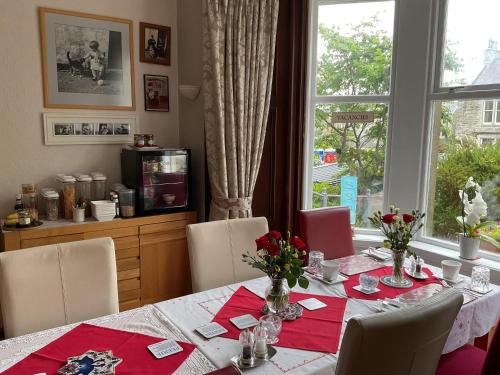 a dining room with a table and a window at Rockvilla Guest House in Lerwick