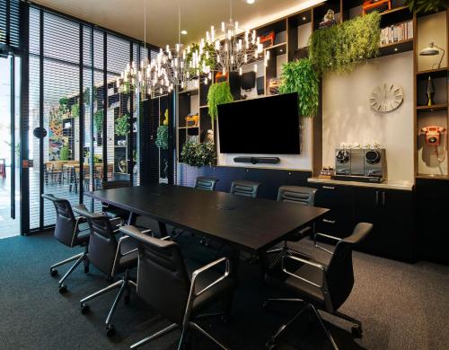 a conference room with a large table and chairs at citizenM Miami South Beach in Miami Beach