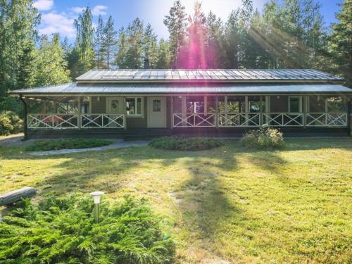 a house with a fountain in the middle of a yard at Holiday Home Villa blombacka by Interhome in Isnäs