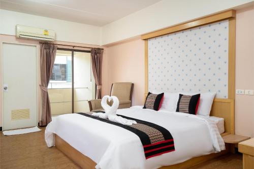 a hotel room with a bed with a swan on it at P-Park Hotel Bangkok in Bangkok