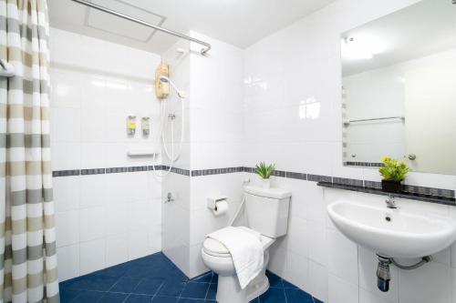 a bathroom with a toilet and a sink at P-Park Hotel Bangkok in Bangkok