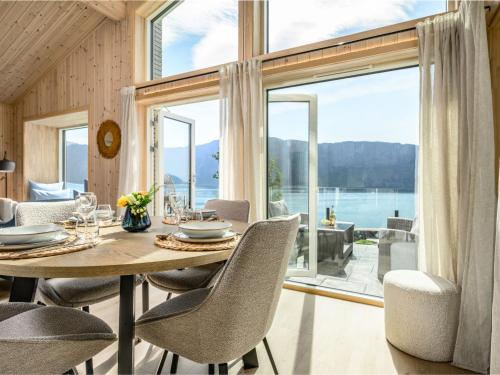 a dining room with a table and chairs and a large window at Holiday Home Hildebu by Interhome in Sørbø