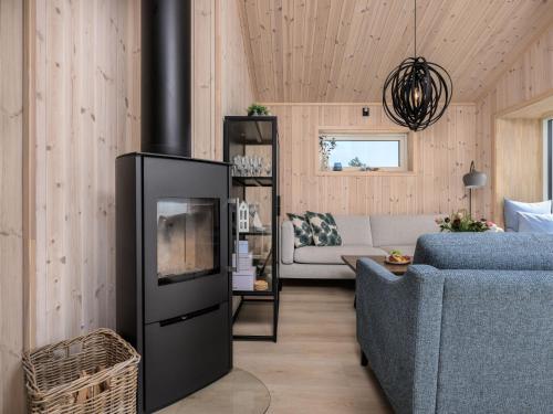 a living room with a couch and a fireplace at Holiday Home Hildebu by Interhome in Sørbø
