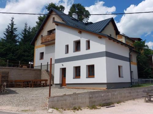 a large white house with a black roof at Apartment Marika 1 by Interhome in Cerny Dul
