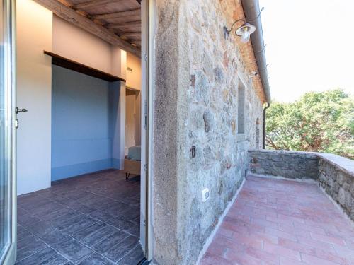 an open door of a house with a stone wall at Holiday Home Oasi di benessere Bio by Interhome in Sassofortino