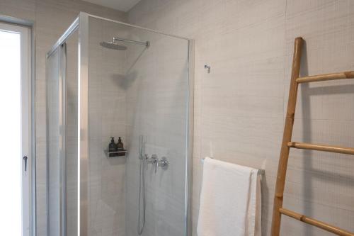 a shower with a glass door in a bathroom at Civetta BLU, Blue Owl Apartments in Trento