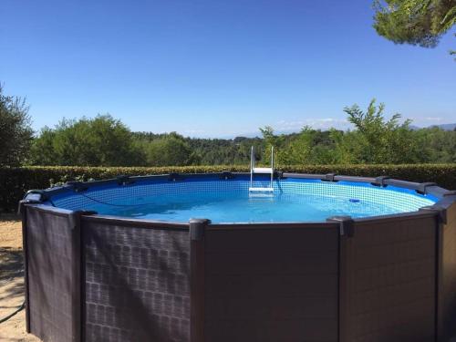 a large swimming pool with a fence around it at Tuscany country house, Poggio Vitale in Lorenzana