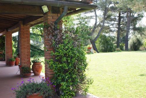 a brick wall with a bunch of plants at Tuscany country house, Poggio Vitale in Lorenzana