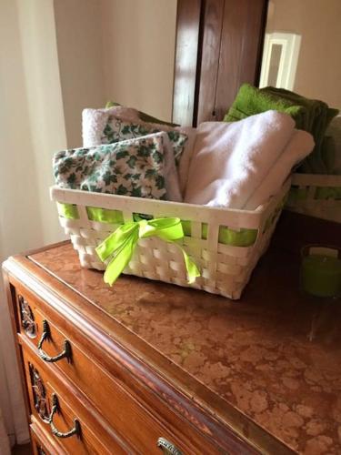 a basket sitting on top of a wooden dresser at Tuscany country house, Poggio Vitale in Lorenzana