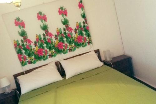 a bedroom with a bed with a painting on the wall at Tuscany country house, Poggio Vitale in Lorenzana