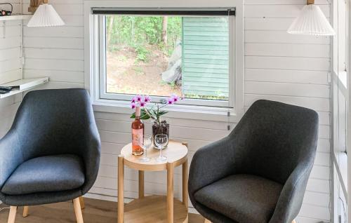 two chairs and a table in a room with a window at A Stunning Home In Nexø With 1 Bedrooms And Wifi in Neksø