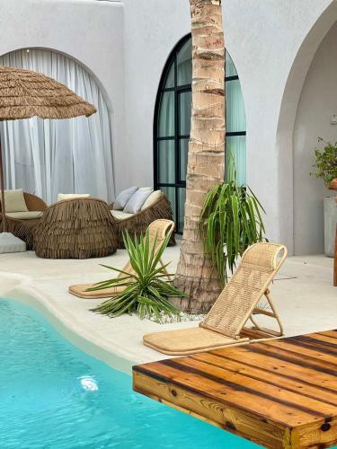 a patio with chairs and a swimming pool at Anara Chalet in Fins