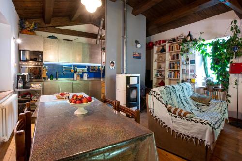 a kitchen with a table with a bowl of fruit on it at Chalet Battista Grotte di Frasassi in Fabriano