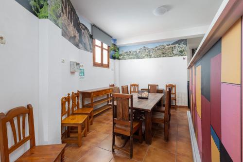 a dining room with a table and chairs at Hostal Entrecaminos in Ardales