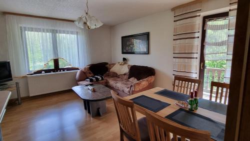 a woman is sitting on a couch in a living room at Altmarkblick in Erbenhausen