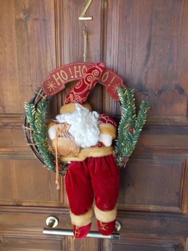 a santa claus ornament hanging on a door at Theasis suites-Ορεινή Φιλοξενία in Kato Trikala Korinthias
