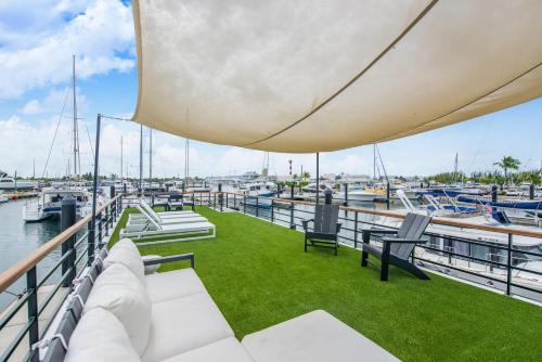 a deck on a boat with grass and chairs at Awai's Floating Villa - Houseboat in Luxury Village in Key West
