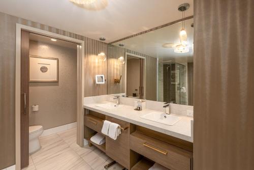 une salle de bain avec deux lavabos et un grand miroir dans l'établissement Viejas Casino & Willows Hotel, à Alpine