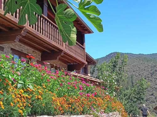 a building with flowers on the side of it at Apartamentos Calm & Nature - Adults Only in Cabezón de Liébana