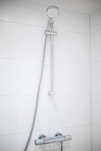 a shower head in a bathroom with a mirror at Villapark in Rotterdam
