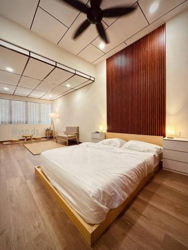 a bedroom with a large bed with a ceiling fan at New Grand Muji Style Villa at Central Penang 16pax in Bukit Lada