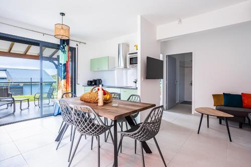 a kitchen and dining room with a table and chairs at Gîte Dalina in Saint-François