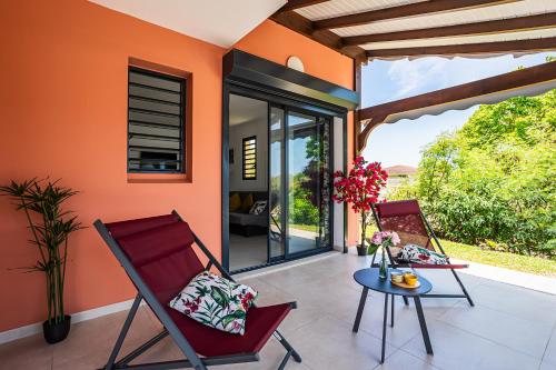 a pair of chairs and a table on a patio at Gîte Dalina in Saint-François