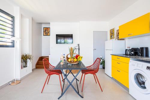 a kitchen with a table with a bowl of fruit on it at Gîte Dalina in Saint-François
