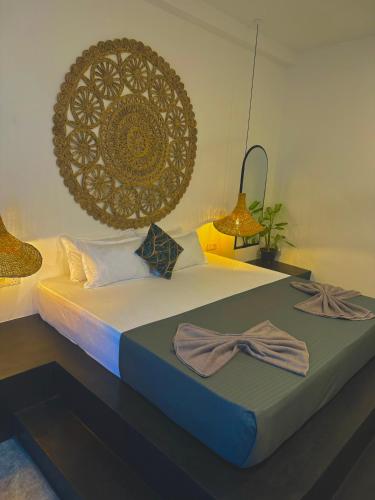 a bedroom with a bed with two towels on it at The Jini House in Ahangama