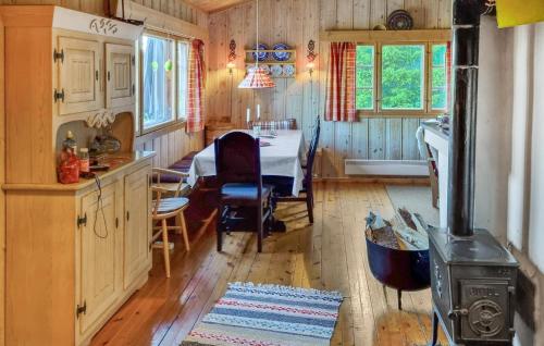 a kitchen and dining room with a table and a stove at Månebu in Tunhovd