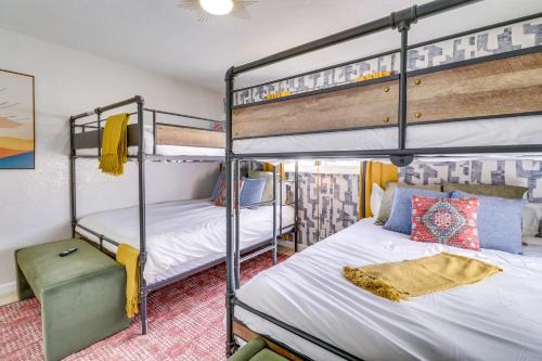 a bedroom with two bunk beds and a desk at Central Albuquerque Getaway with Hot Tub and Grill! in Albuquerque