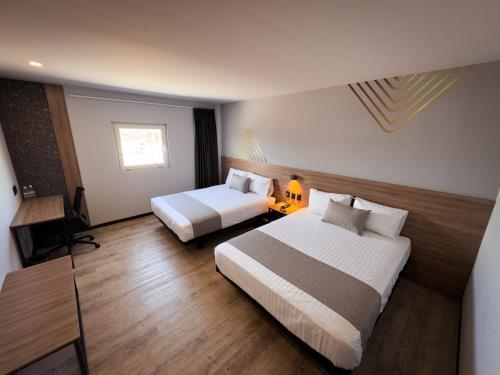 Postel nebo postele na pokoji v ubytování Avanta Hotel & Villas Querétaro