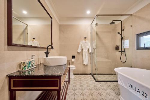 a bathroom with a tub and a sink and a shower at Boutique Villa 22 - Biệt Thự Trung Tâm Đà Lạt in Da Lat