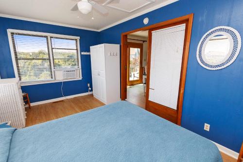 a blue bedroom with a bed and a window at Semi-Oceanfront, Close to Beach Access! SA2, Wadel in Sanderling