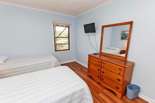 a bedroom with two beds and a dresser with a mirror at Semi-Oceanfront, Close to Beach Access! SA2, Wadel in Sanderling