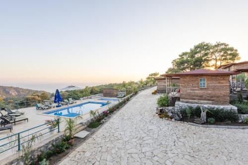 a resort with a swimming pool and a building at Kadir's Eco Life in Kumluca