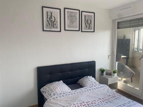 a bedroom with a bed and three pictures on the wall at Appartement 3 Chambres Evry plein Centre ville in Évry-les-Châteaux