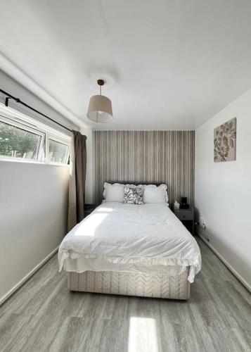 a bedroom with a white bed and a window at Fabulous 1Bed Apt with Balcony in Central Birmingham in Birmingham