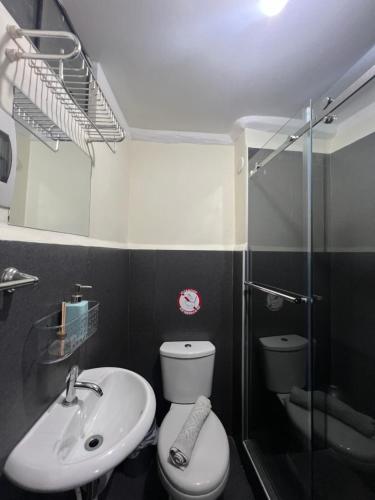 a bathroom with a toilet and a sink and a shower at Lima Airport Tampu in Lima